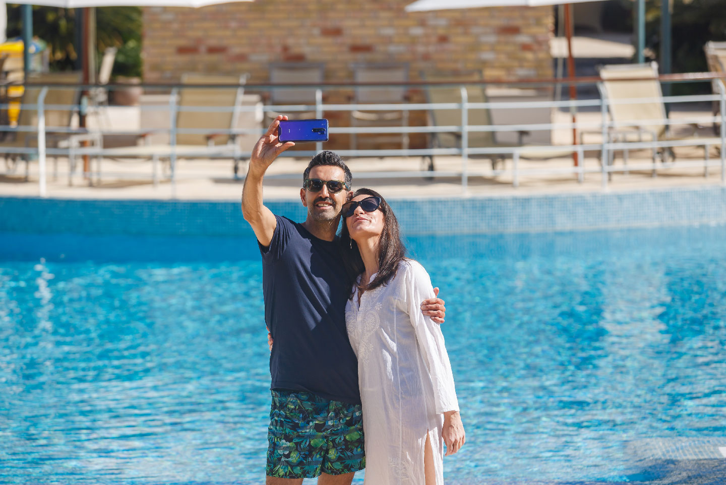 Couple at Pool La Quinta Menorca by PortBlue Boutique Hotel